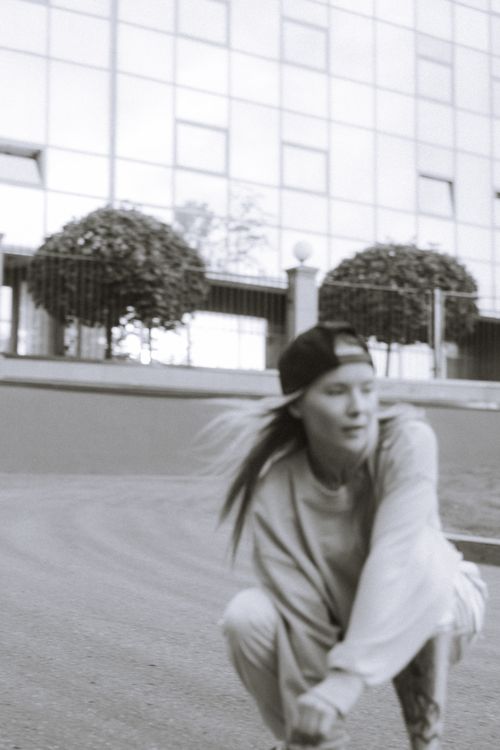 Free Black and white image of a young skater in action, capturing a modern urban feel. Stock Photo