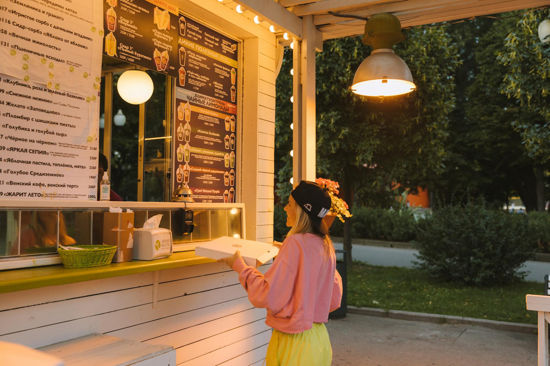 Woman Collecting Her Order from a Restaurant