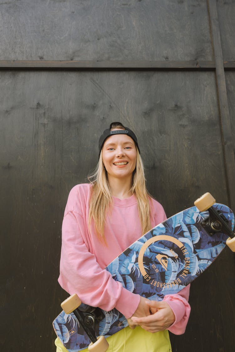 Blond Woman Holding A Longboard