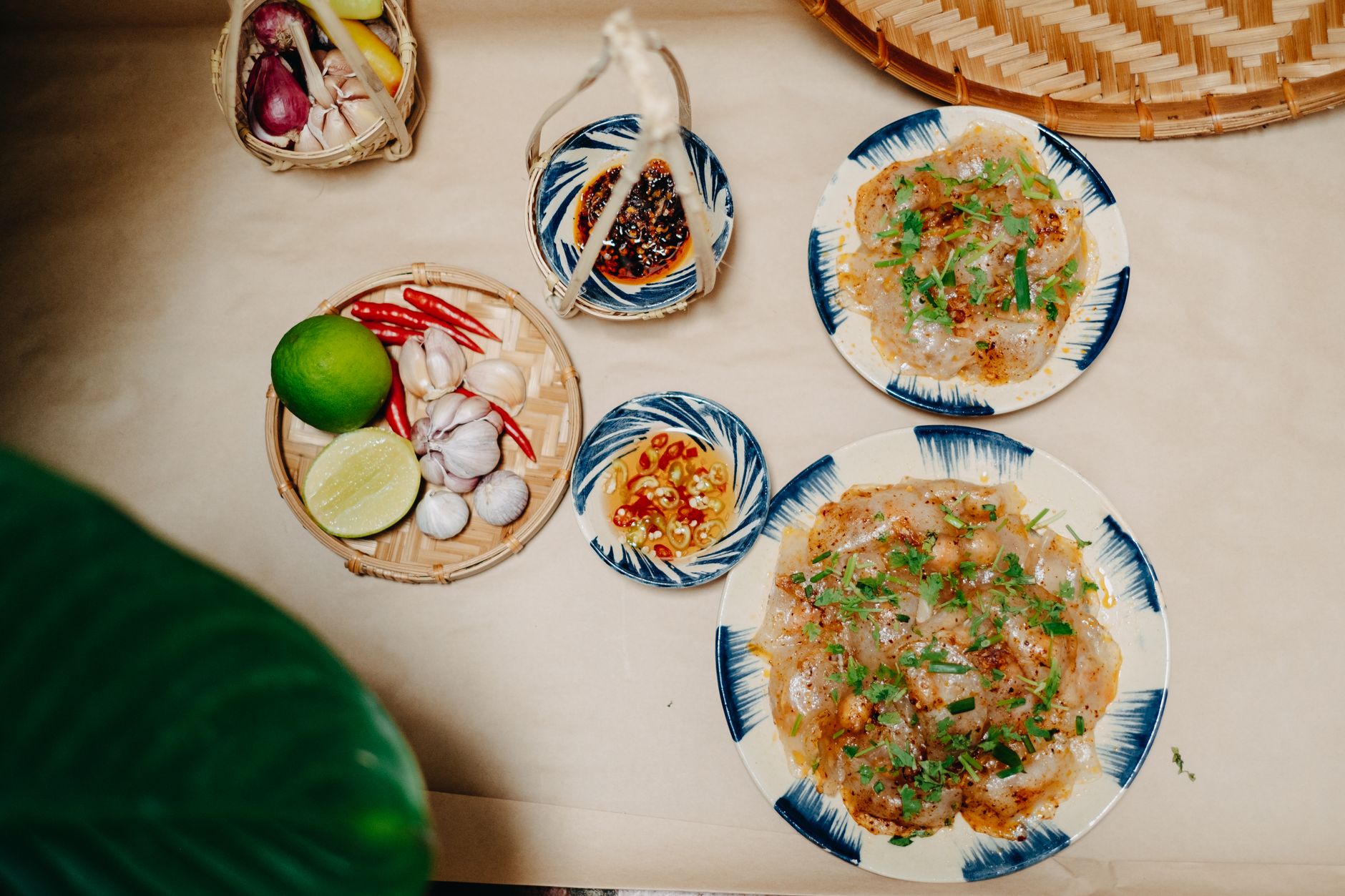 Top view of traditional Vietnamese Banh Loc with fresh ingredients and garnishes.