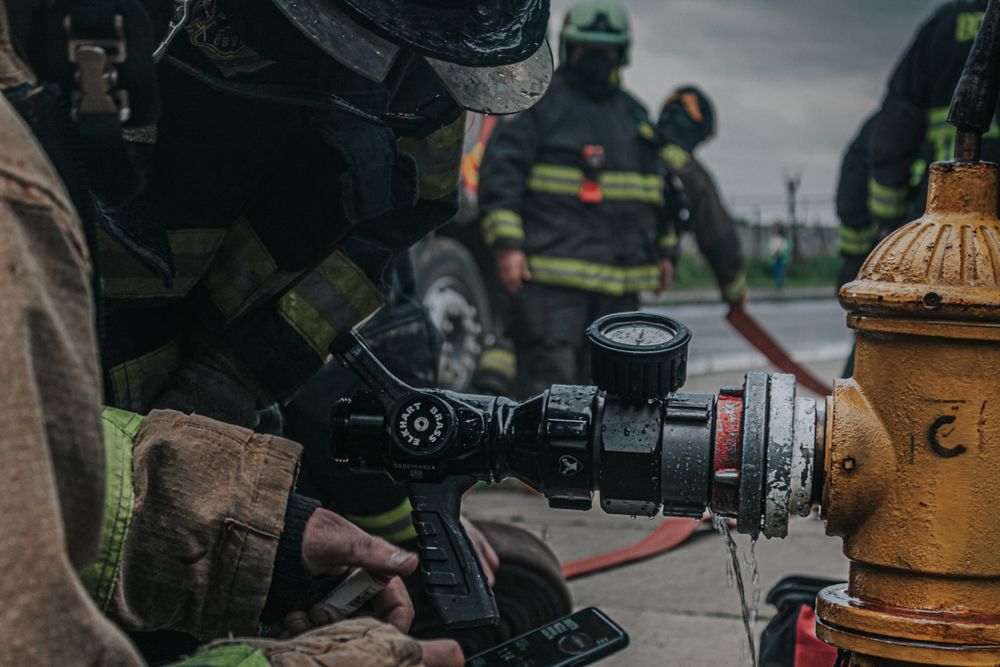 Firefighters connecting a hose to a hydrant