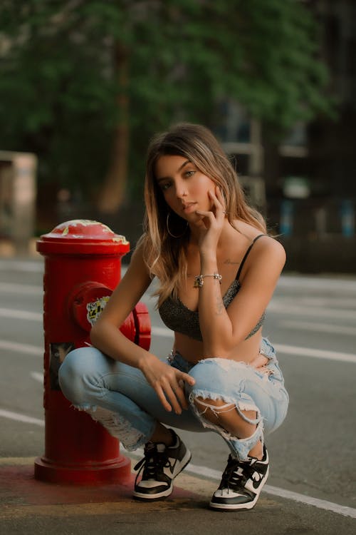 Beautiful Woman Crouching Beside Fire Hydrant