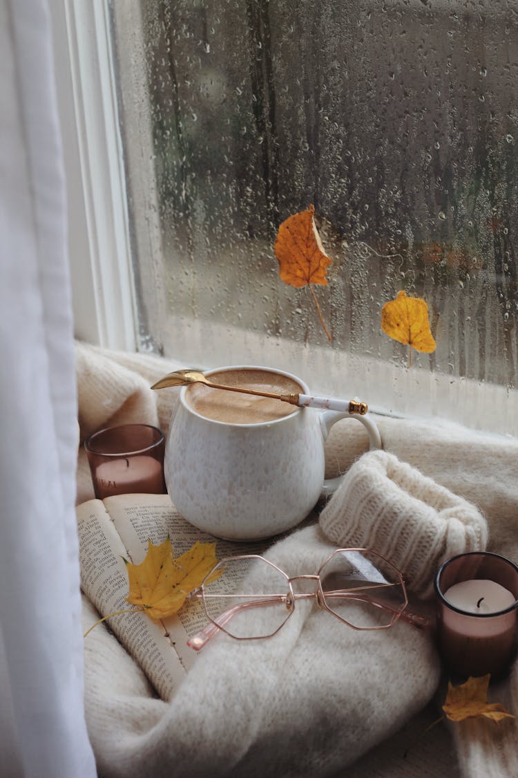 Coffee, Glasses And Sweater On Book In Autumn Scene