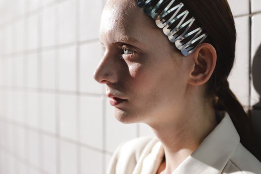 Portrait of a woman with a hair clip, showcasing natural beauty and contemplation.