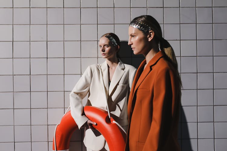 Models In Oversized Blazers Holding A Lifebuoy