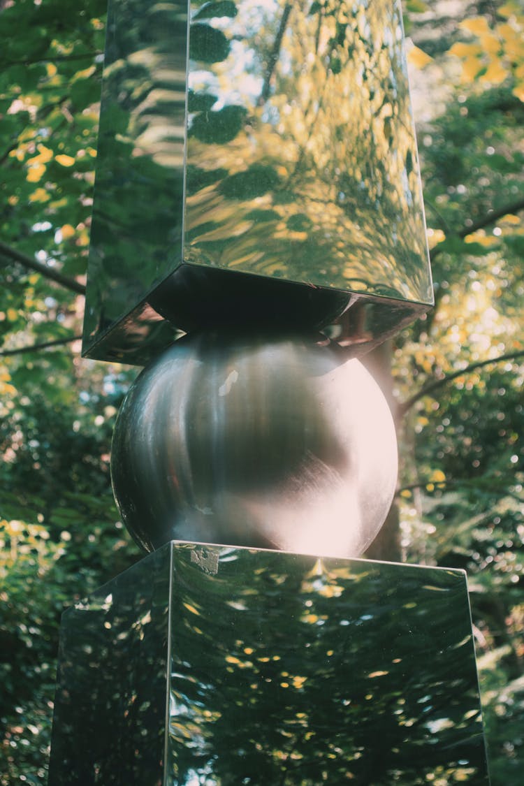 Shiny Mirror-Like Sculpture In A Park