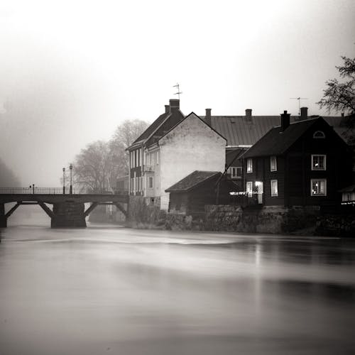 Waterfront Houses by a River Photographed in Long Exposure 