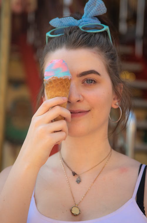 Woman in White Tank Top Holding Ice Cream Cone