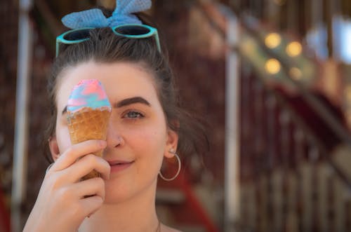 Woman in Blue Headband Holding Ice Cream Cone