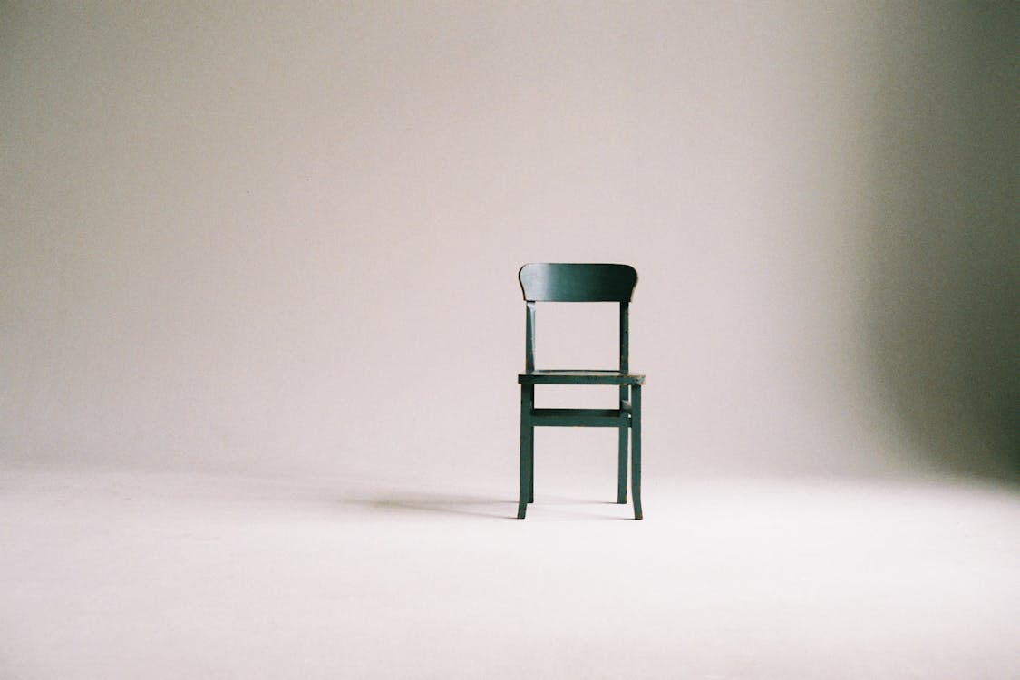 Green Wooden Chair on White Surface