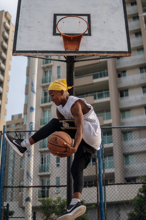 Man doing tricks with basketball ball mid-air