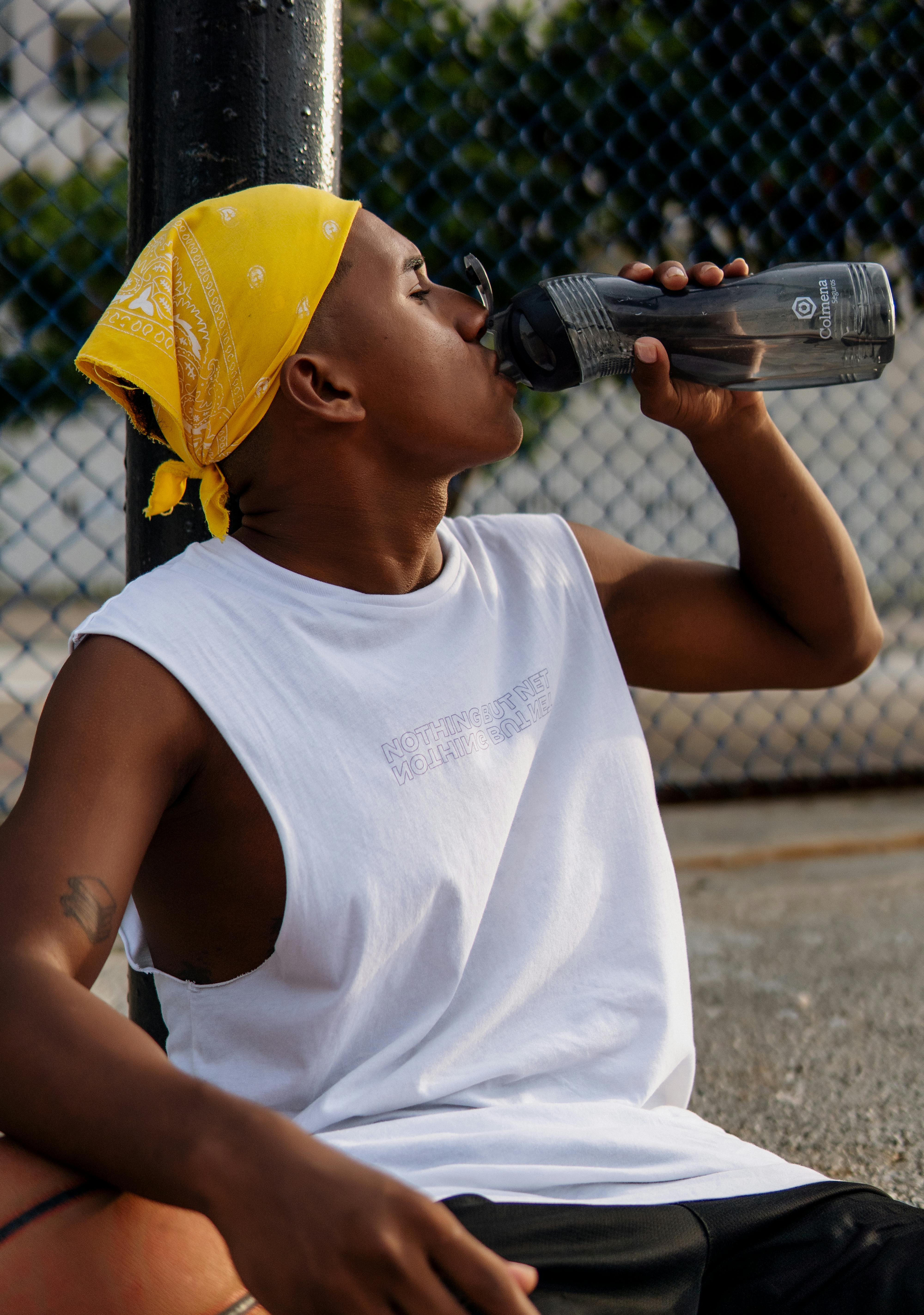 man drinking from water bottle