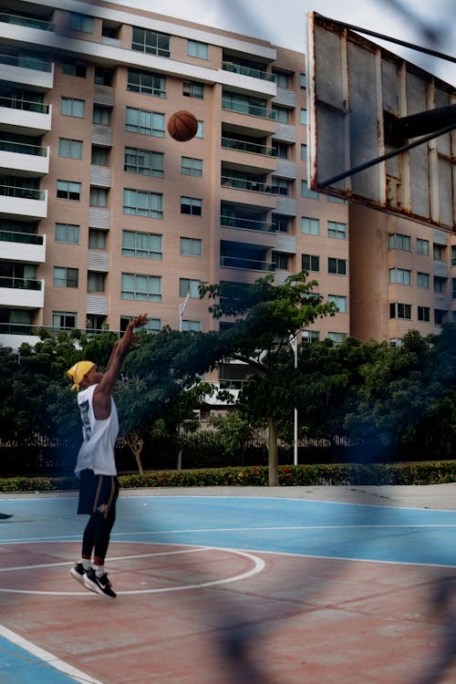 Free Man Shooting a Basketball Stock Photo