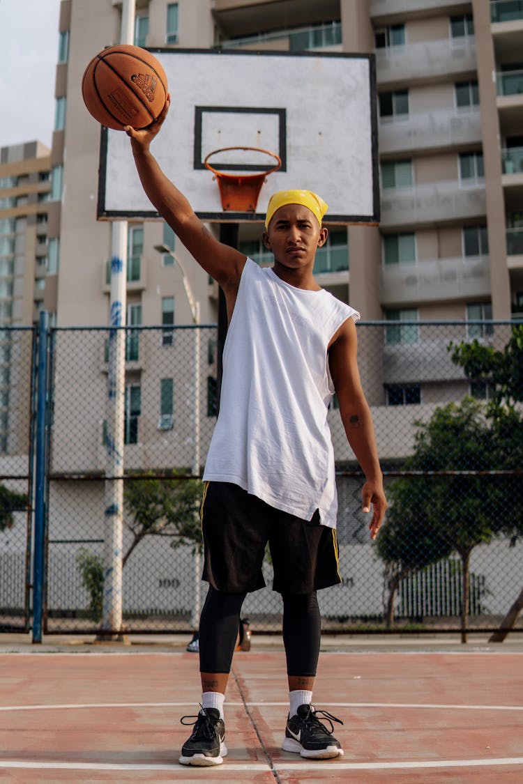 Man Holding Aloft Basketball Ball