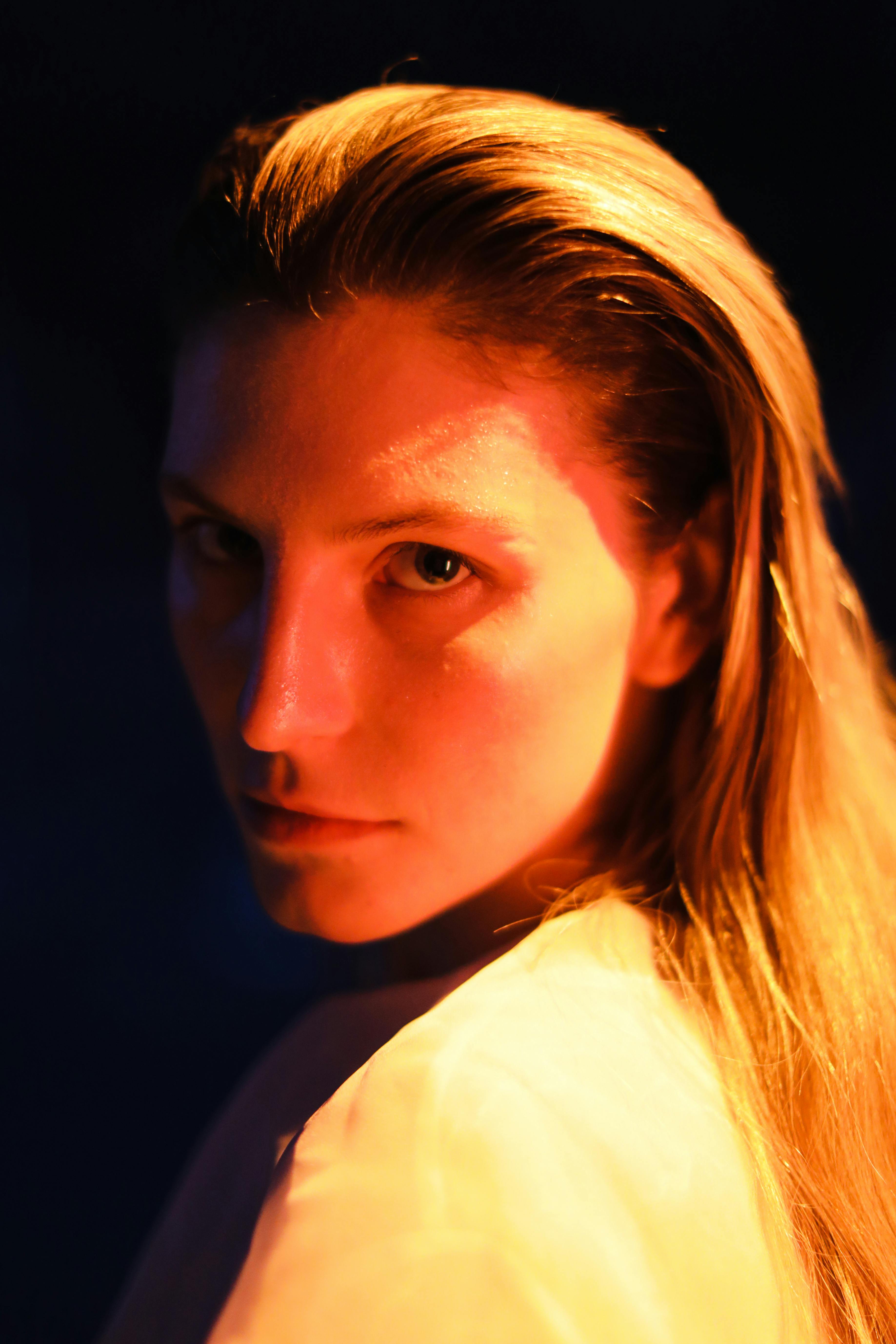 Striking portrait of a person with dramatic lighting and intense gaze.