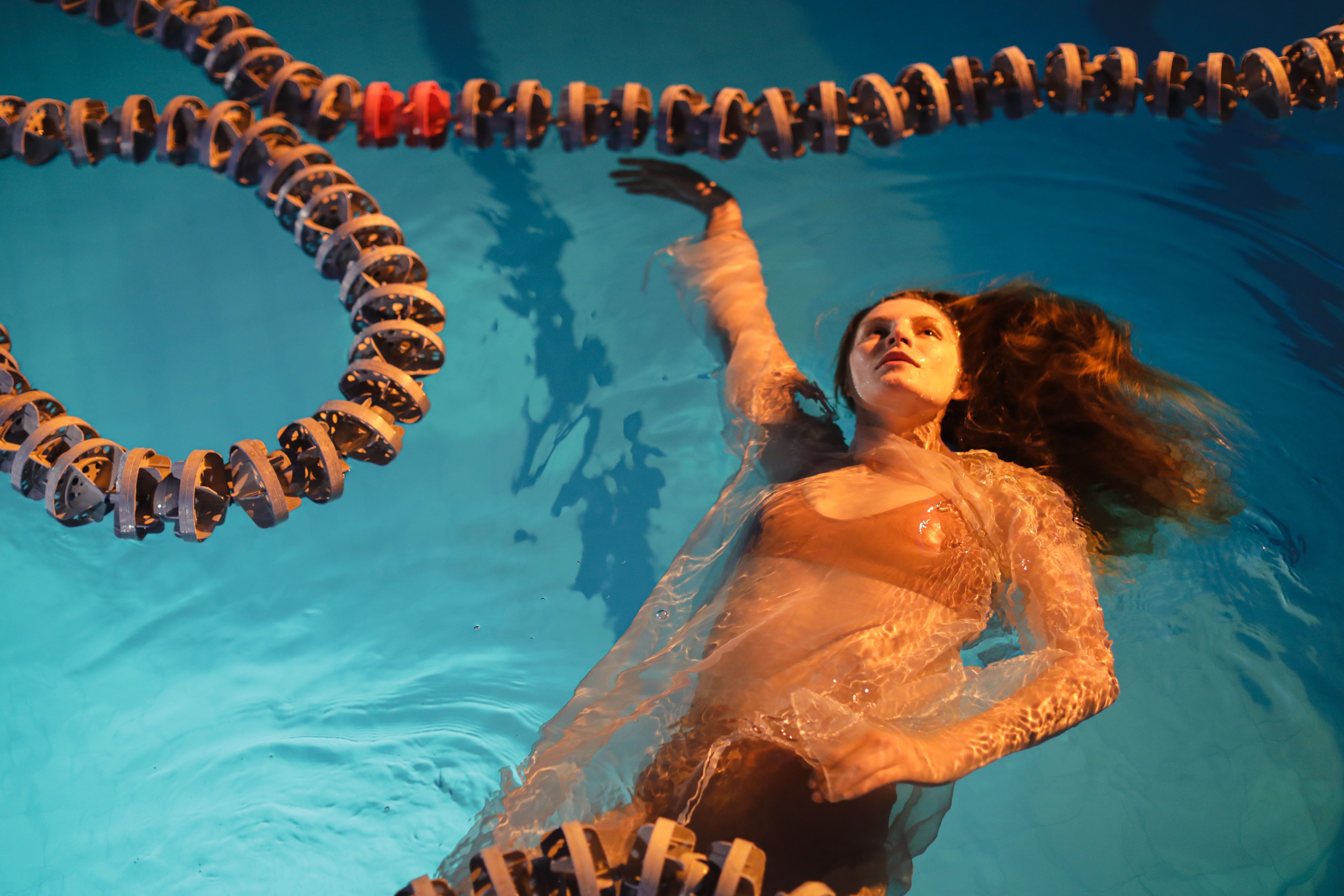 Photo of a Woman Floating in a Pool · Free Stock Photo