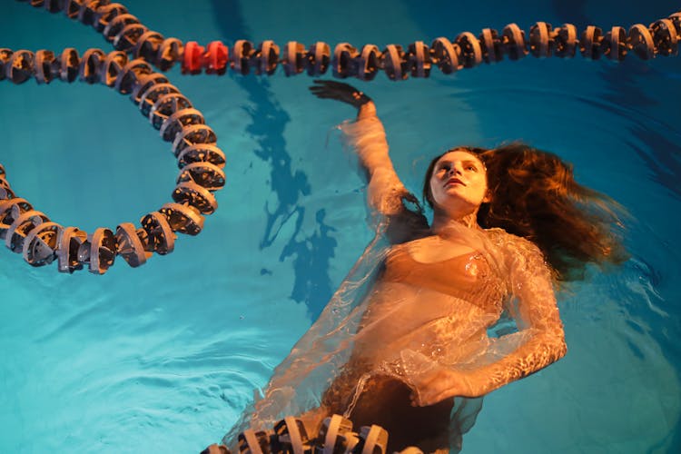 Photo Of A Woman Floating In A Pool