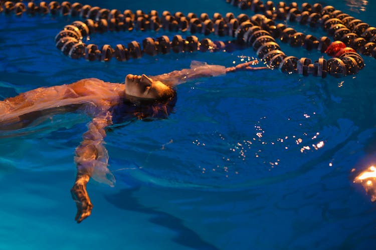 Woman Floating In A Pool