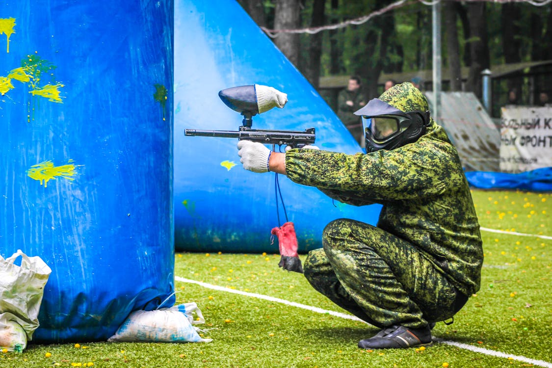 Person in Full Protective Gear using Paintball Gun