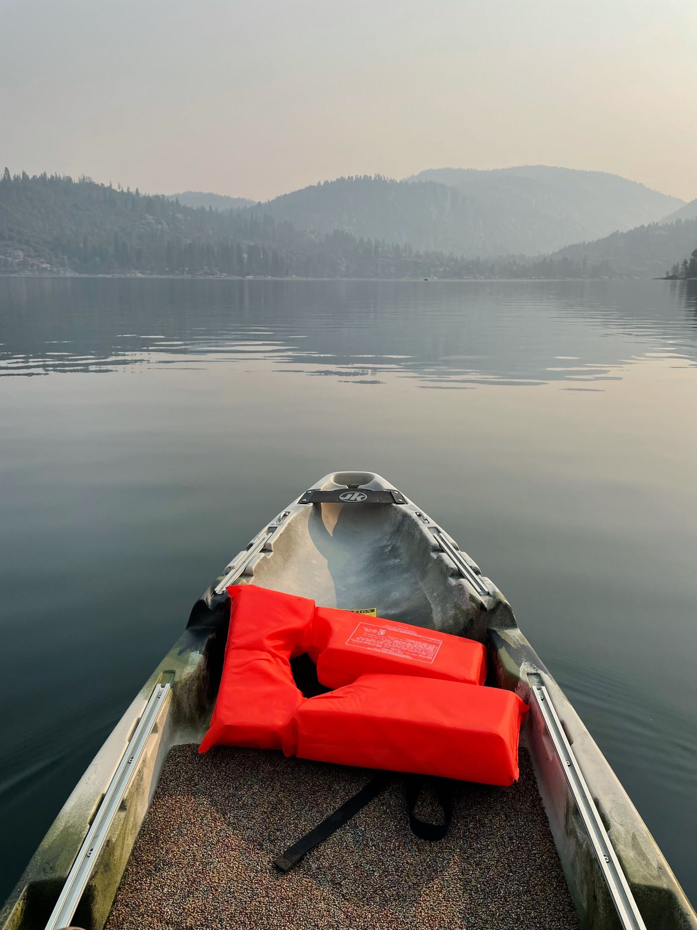 Kayak and water safety equipment prepared beside the shore