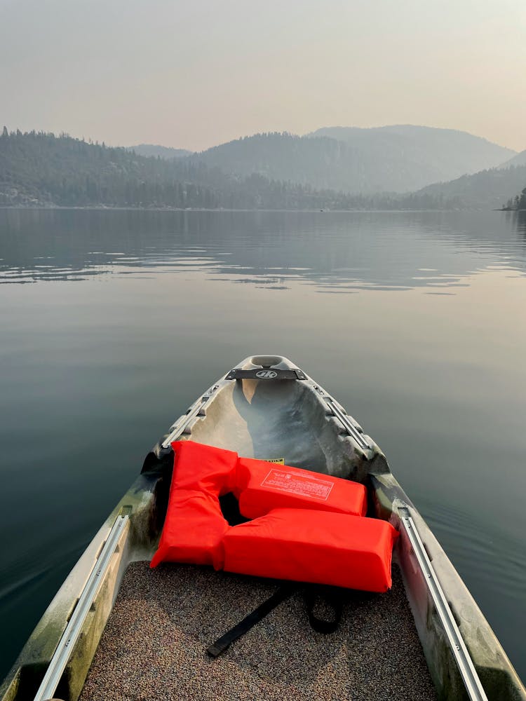 Kayak With A Life Jacket And The View Of Mountains