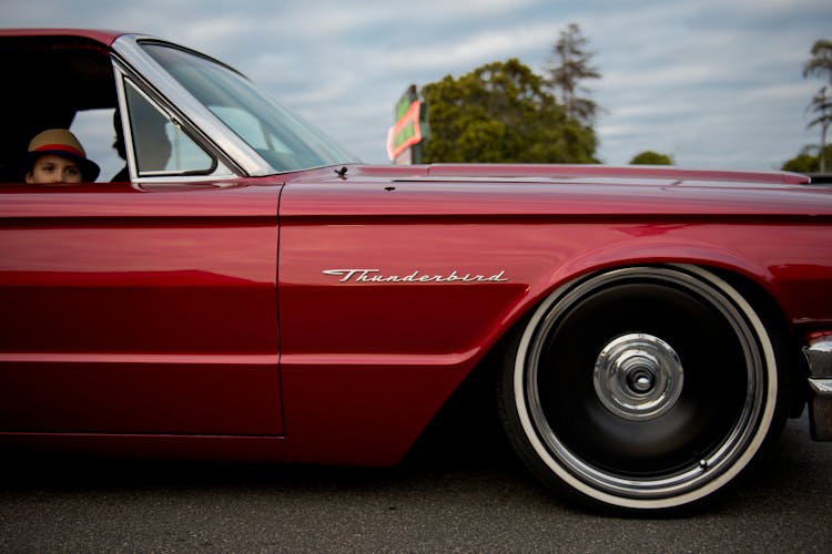 People Inside Red Thunderbird Car