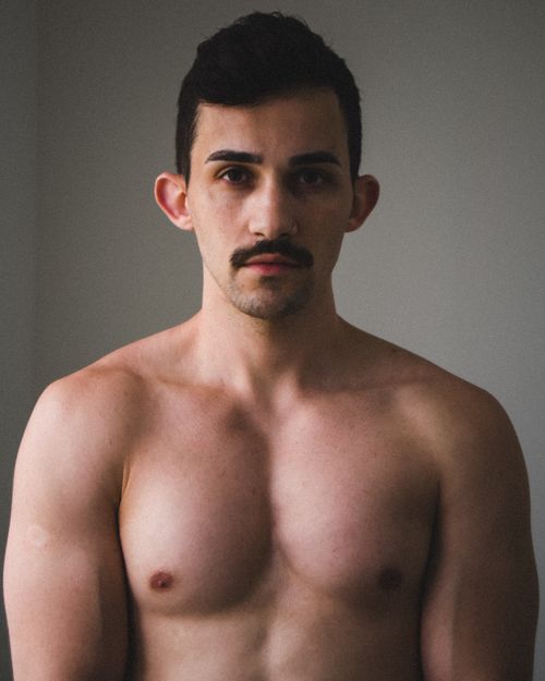 Free Portrait of a shirtless man with a moustache, highlighting masculinity and strength. Stock Photo