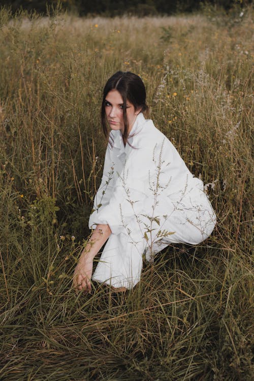 A Model in White Clothes in a Grass Field