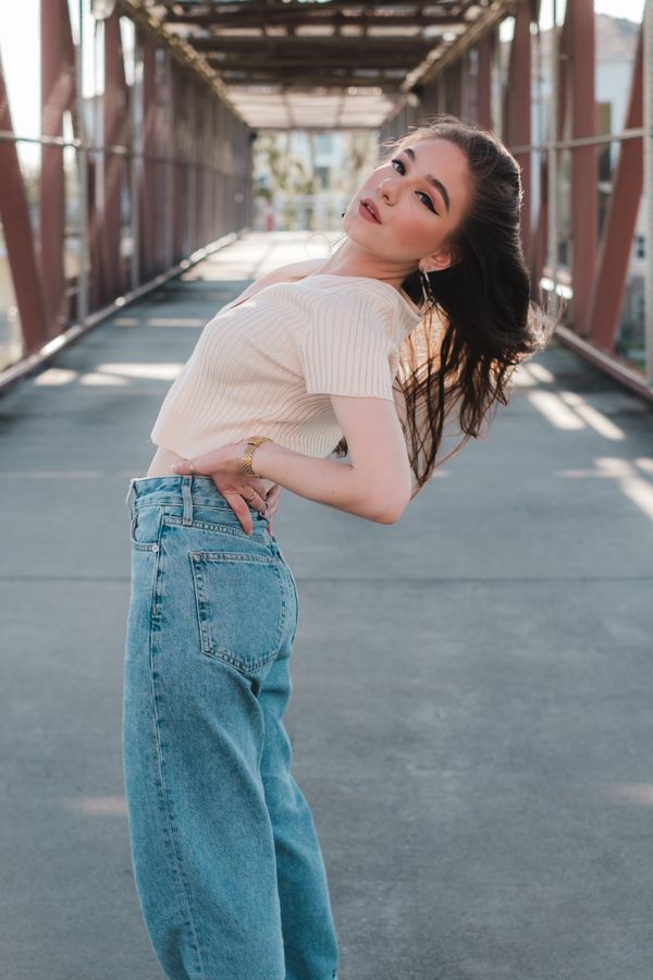 Cream knit bodysuit with light-wash barrel jeans
