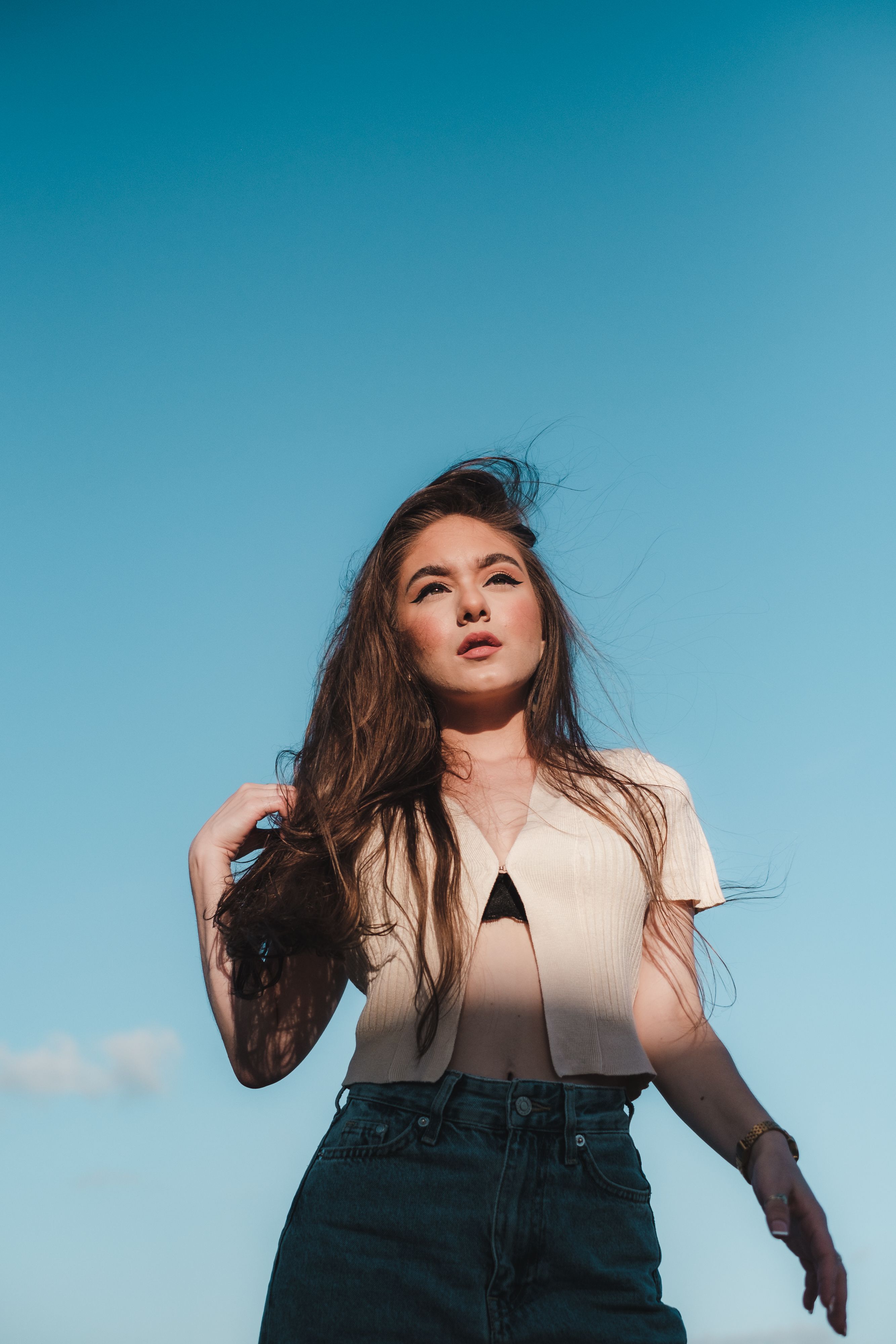 Beautiful Woman in Beige Crop Top and Blue Jeans · Free Stock Photo