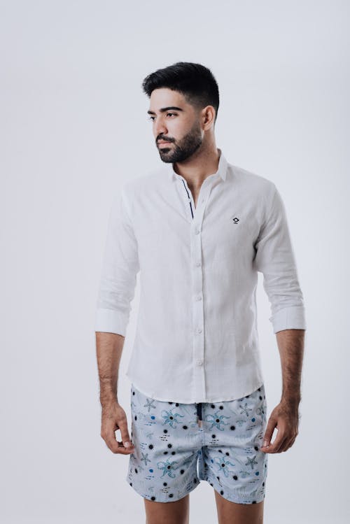 Free Close-Up Shot of a Bearded Man Wearing White Long Sleeve and Shorts Stock Photo