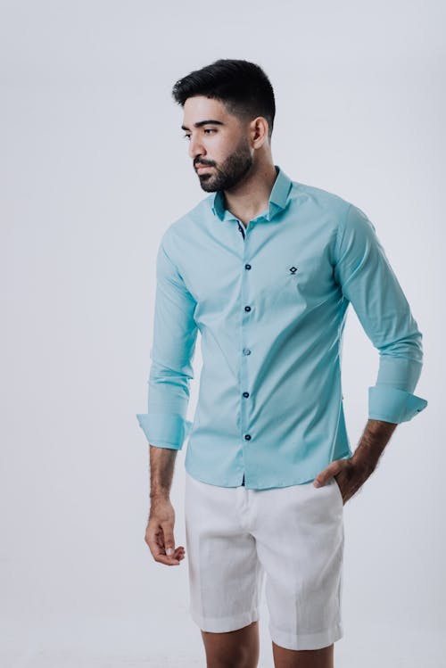 Man in Light Blue Long Sleeve Shirt Posing