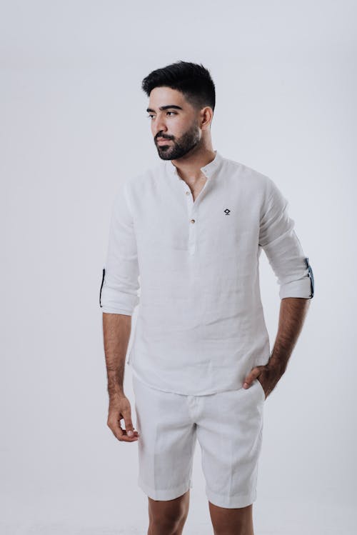 Free Close-Up Shot of a Bearded Man Wearing White Long Sleeve and White Shorts Stock Photo