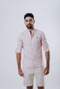 Man in Pink Button Up Shirt and White Shorts