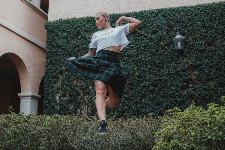 Woman Jumping Over Bush