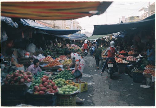 Bustling outdoor market scene with colorful produce and vendors.