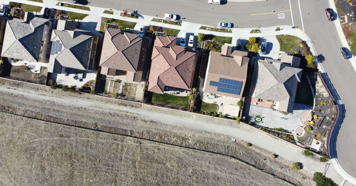 Overhead view of suburban houses with solar panels in Dublin, CA neighborhood.