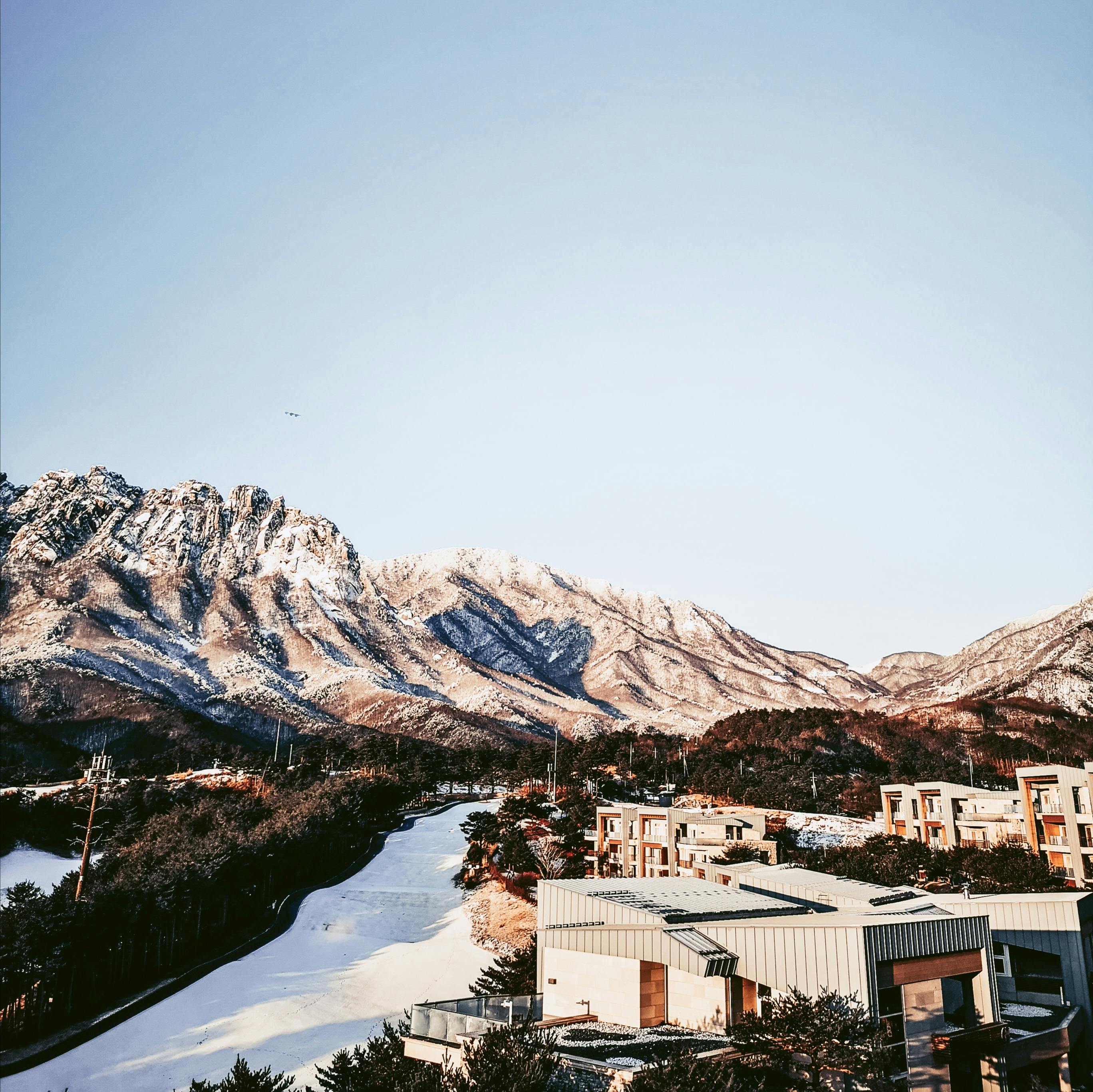 Prescription Goggle Inserts - Scenic view of snow-covered Seoraksan Mountain and modern architecture in South Korea.