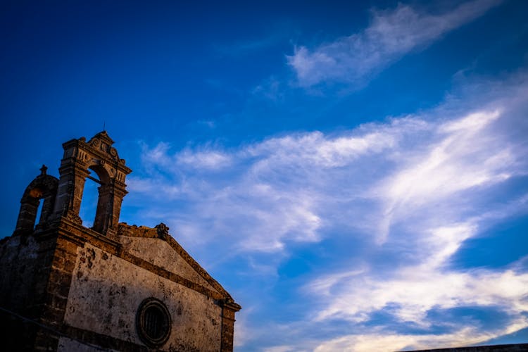 Brown Concrete Chapel Under Cloudy Blue Sky