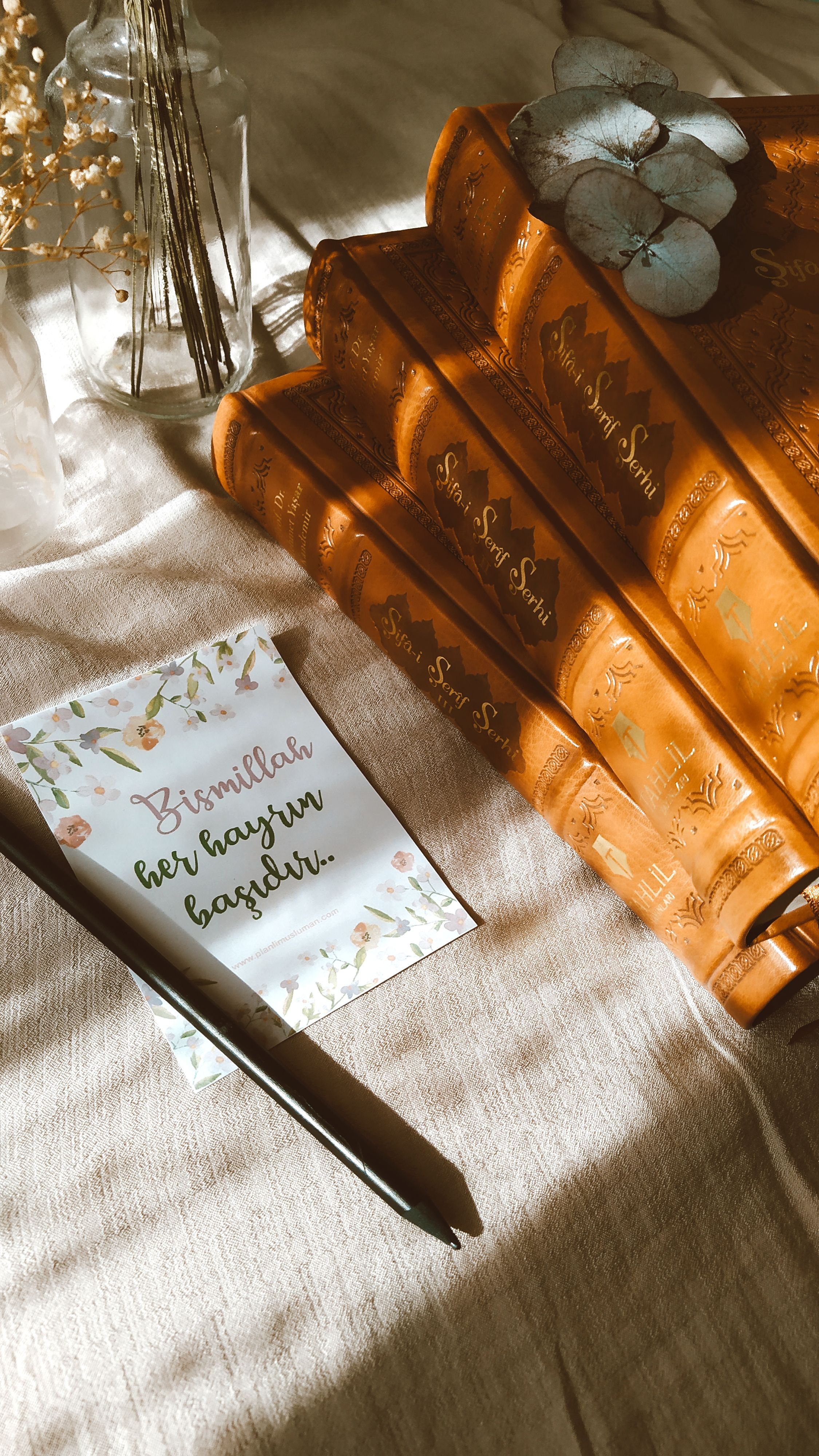 Cozy scene with books and a note bathed in warm sunlight, creating a rustic ambiance.