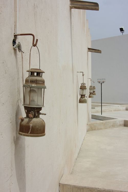Free Vintage lanterns adorn a traditional wall in Sharjah, reflecting Middle Eastern architecture. Stock Photo