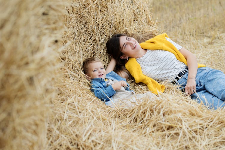 A Mother And Son Lying On Hay 