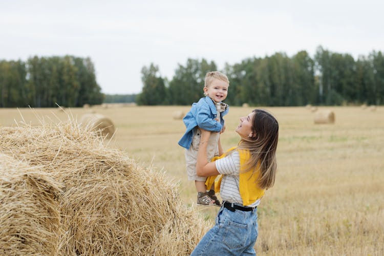 A Woman Carrying Her Child