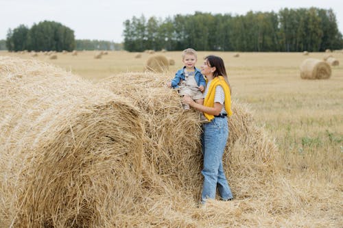 Boy Sitting on Hay Bale