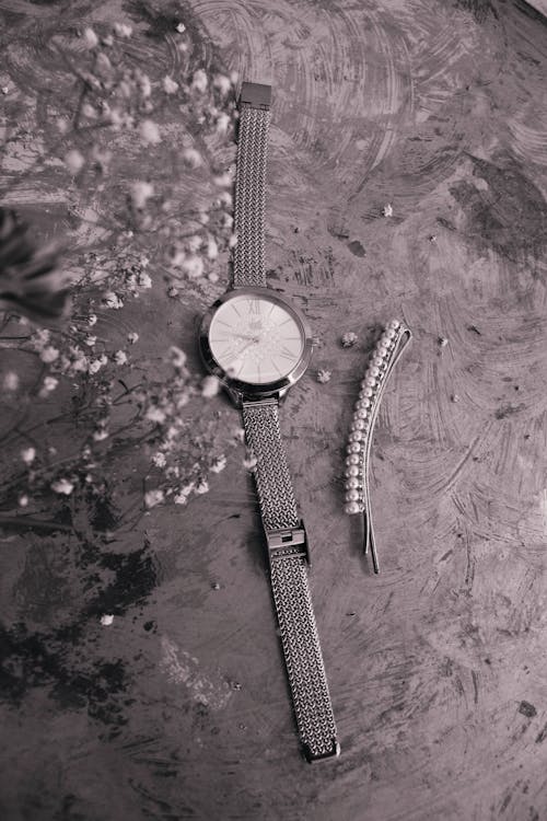 Black and White Photo of a Watch on the Ground