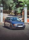 Blue Honda Sedan Parked Beside Brown Wooden Fence