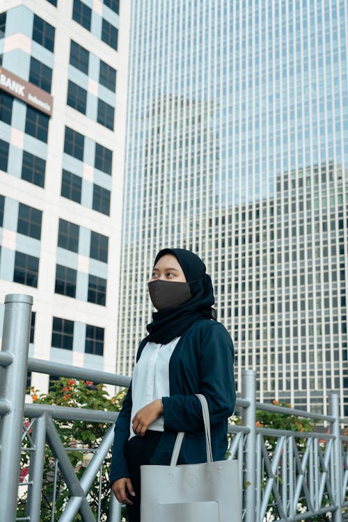 Free Woman in Black Hijab Standing Near the Metal Fence Stock Photo