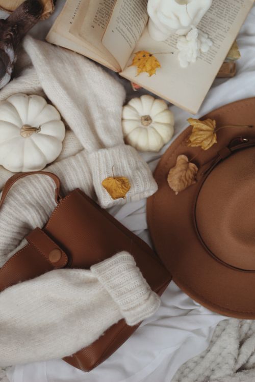 Free Elegant autumn flat lay with pumpkins, sweater, book, and accessories, capturing cozy seasonal vibes. Stock Photo