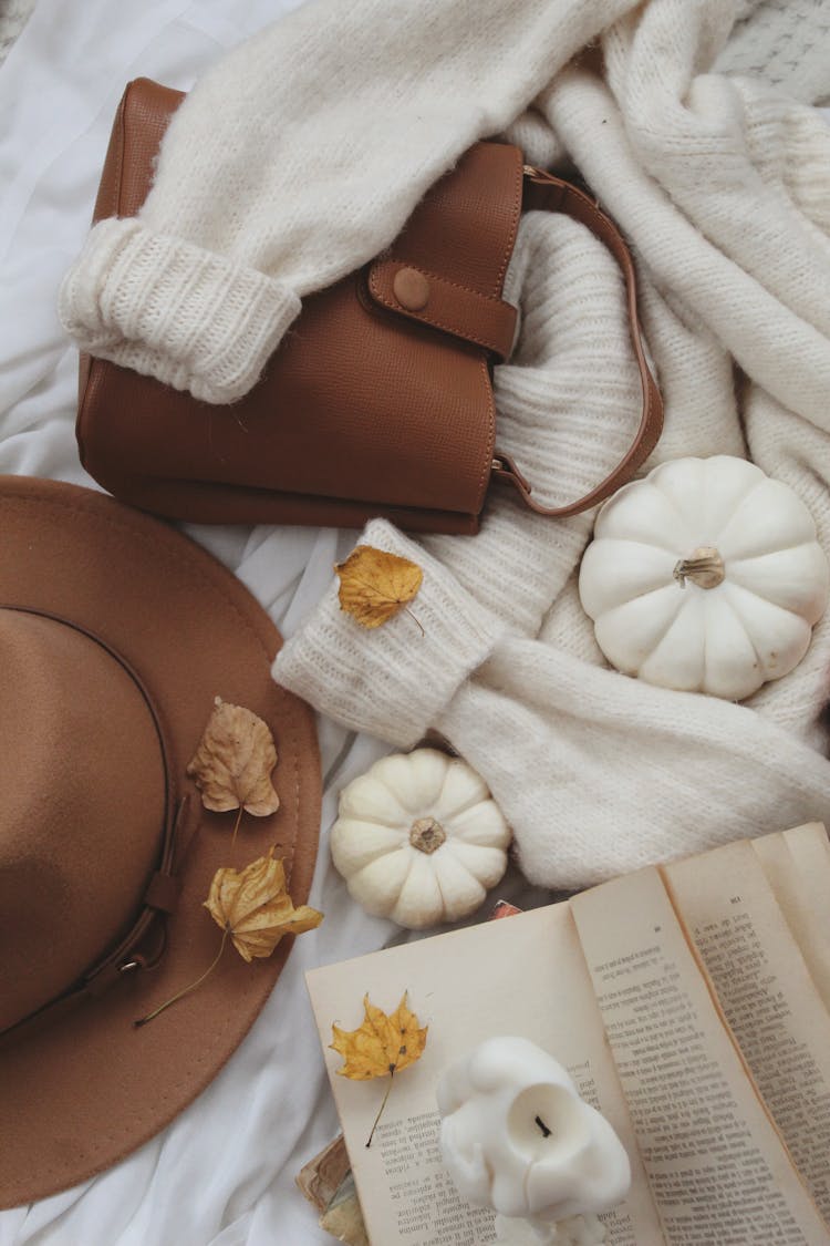 Candles, Autumn Leaves And Bronze Bag On Sweater