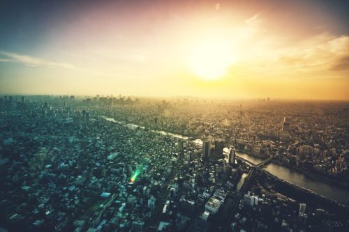 Free Captivating aerial view of a sprawling cityscape and river at sunrise, showcasing skyscrapers and skyline. Stock Photo